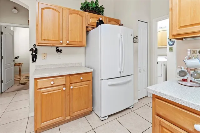 a white refrigerator freezer sitting in a kitchen
