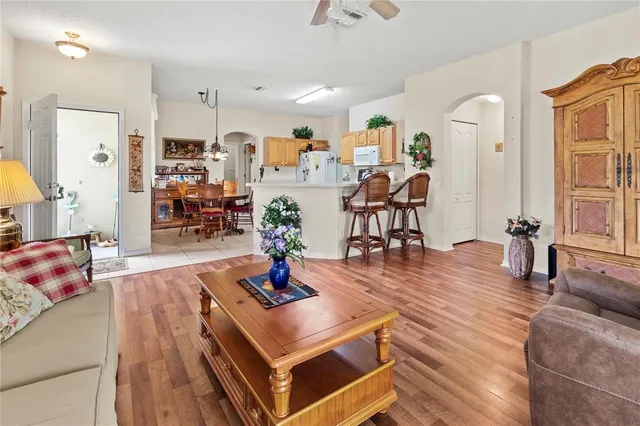 a living room with furniture a wooden floor and sink