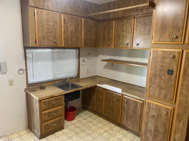 a kitchen with stainless steel appliances granite countertop a refrigerator and a stove