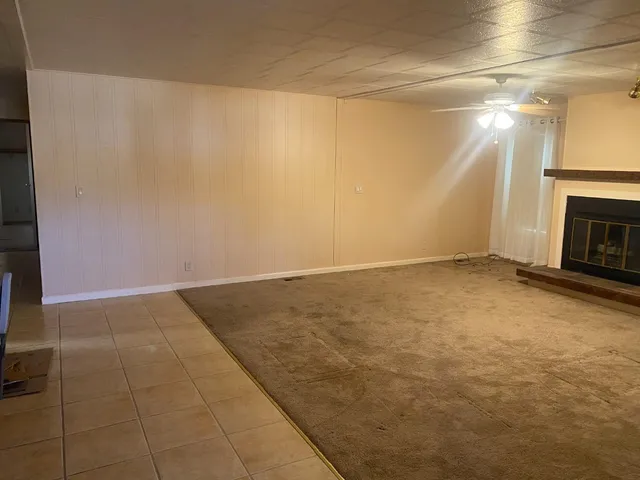 a view of an empty room with a fireplace