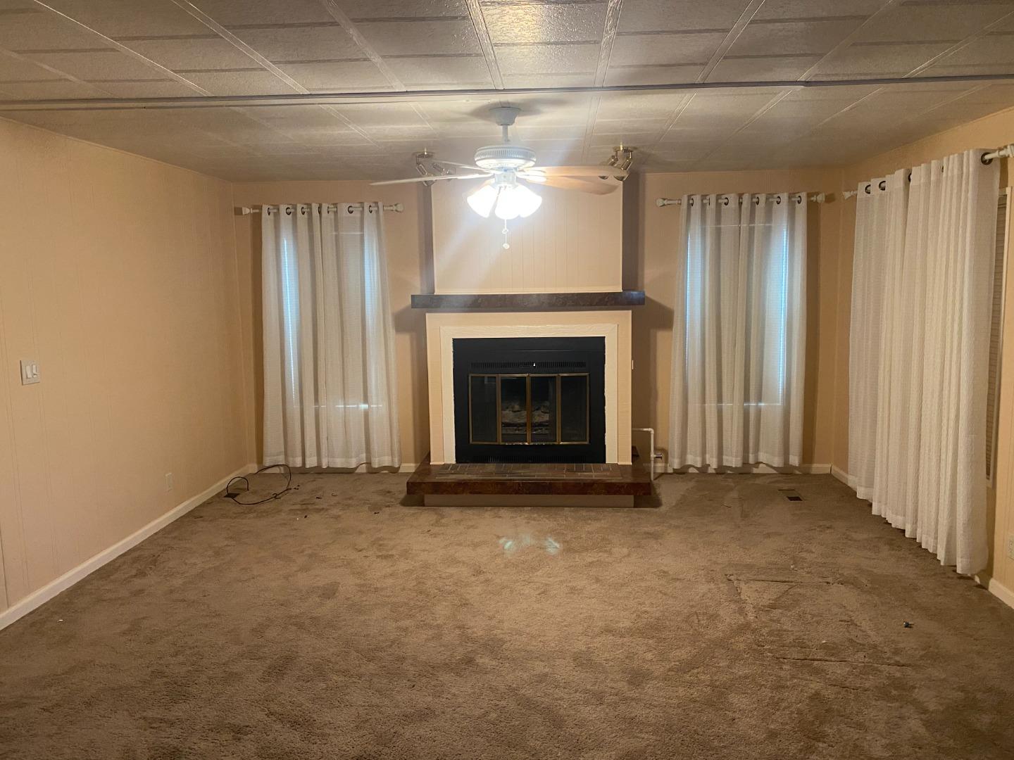 827 Villa Teresa Way, Unit 827 San Jose, CA 95123 - Photo 7 of 21 an empty room with windows and fireplace