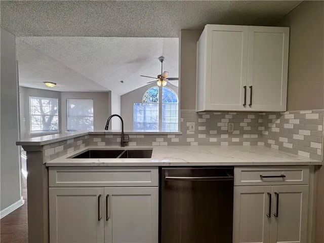 a kitchen with a sink and cabinets