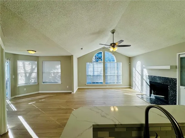 a living room with fireplace furniture and a fireplace