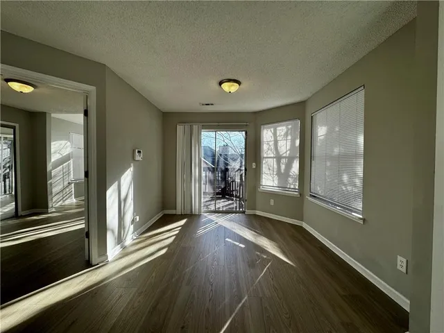 a view of a livingroom with wooden floor and furniture
