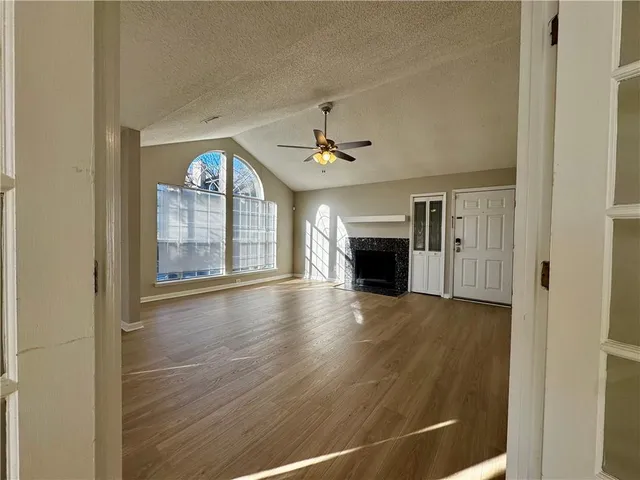 a view of empty room with a fireplace