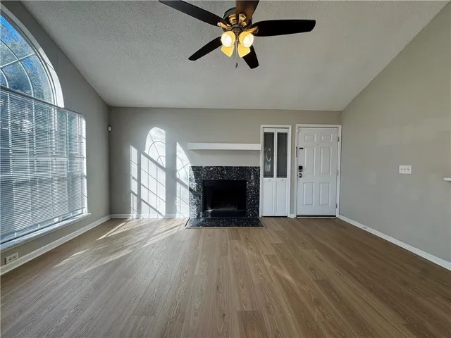 wooden floor fireplace and natural light in room