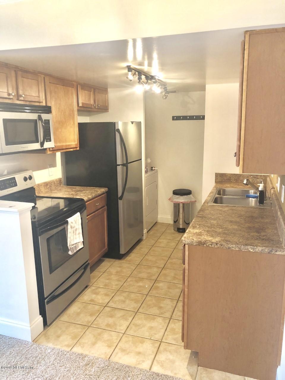 3737 Loretto Road, Unit 505 Jacksonville, FL 32223 - Photo 7 of 15 a kitchen with stainless steel appliances granite countertop a sink a stove a refrigerator and island
