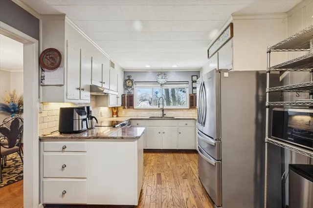 a kitchen with a refrigerator and microwave