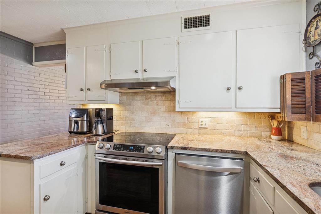 6001 Jacqueline Road Fort Worth, TX 76112 - Photo 13 of 26 a kitchen with granite countertop white cabinets and stainless steel appliances