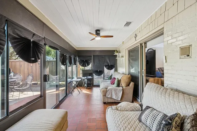 a living room with furniture and a floor to ceiling window