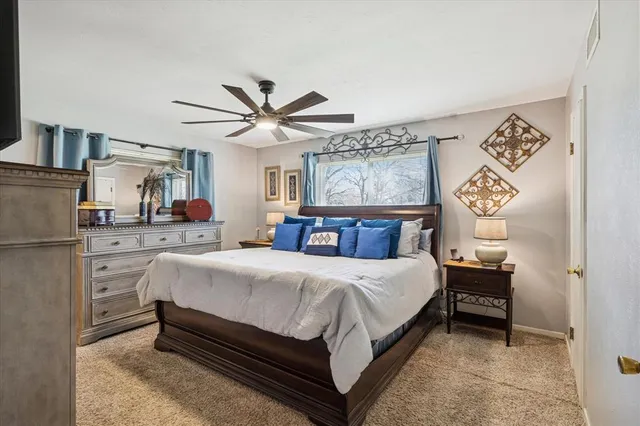 a bedroom with a bed and a chandelier