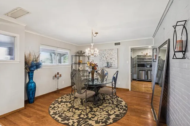 a living room with dining room and wooden floor