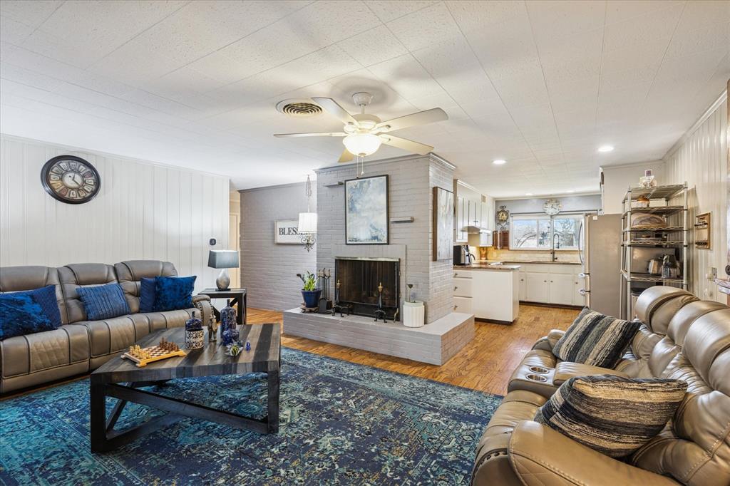 6001 Jacqueline Road Fort Worth, TX 76112 - Photo 9 of 26 a living room with furniture kitchen view and a fireplace