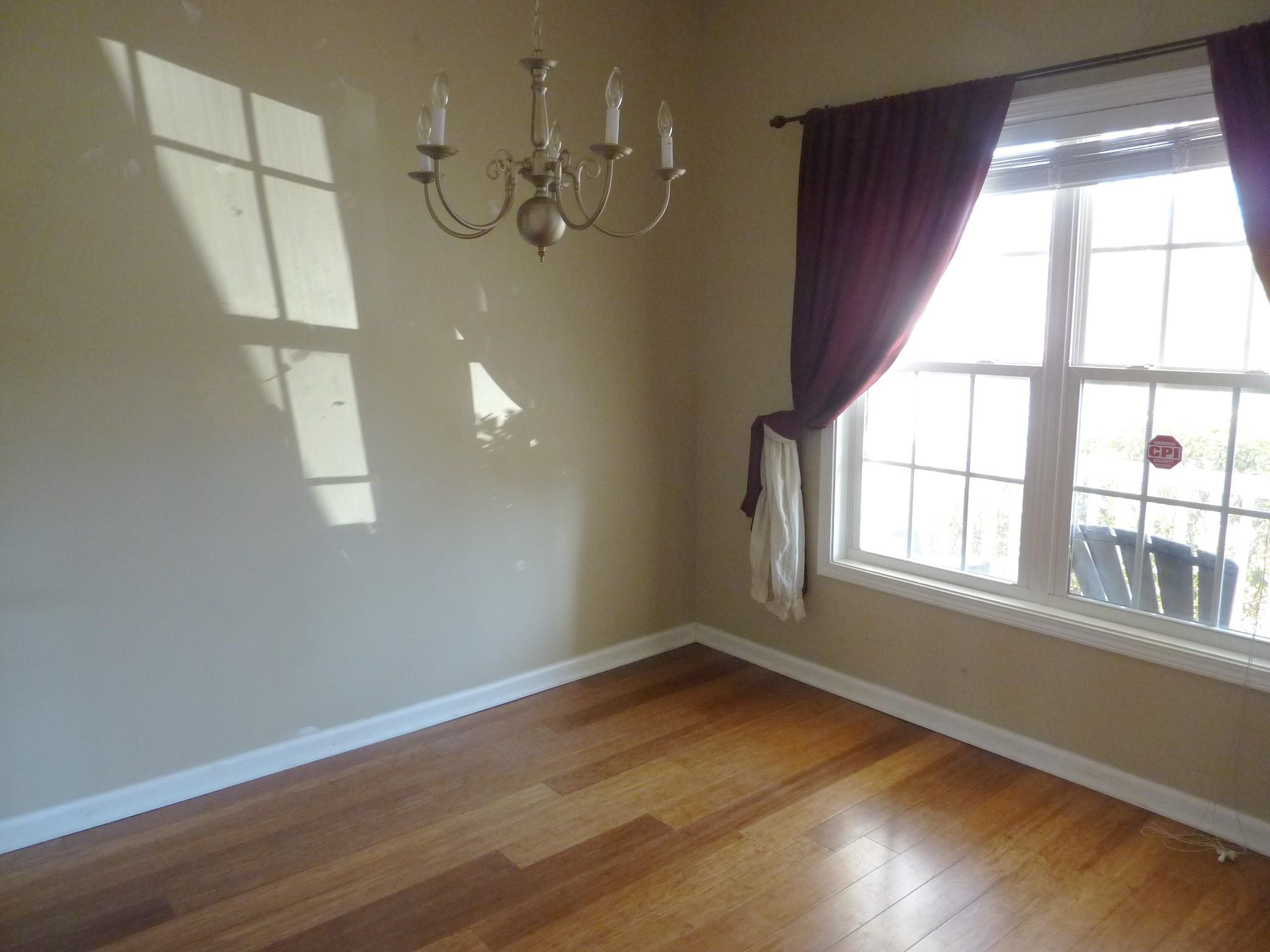 Separate dining room with wood laminate flooring and large double window! Dining Room