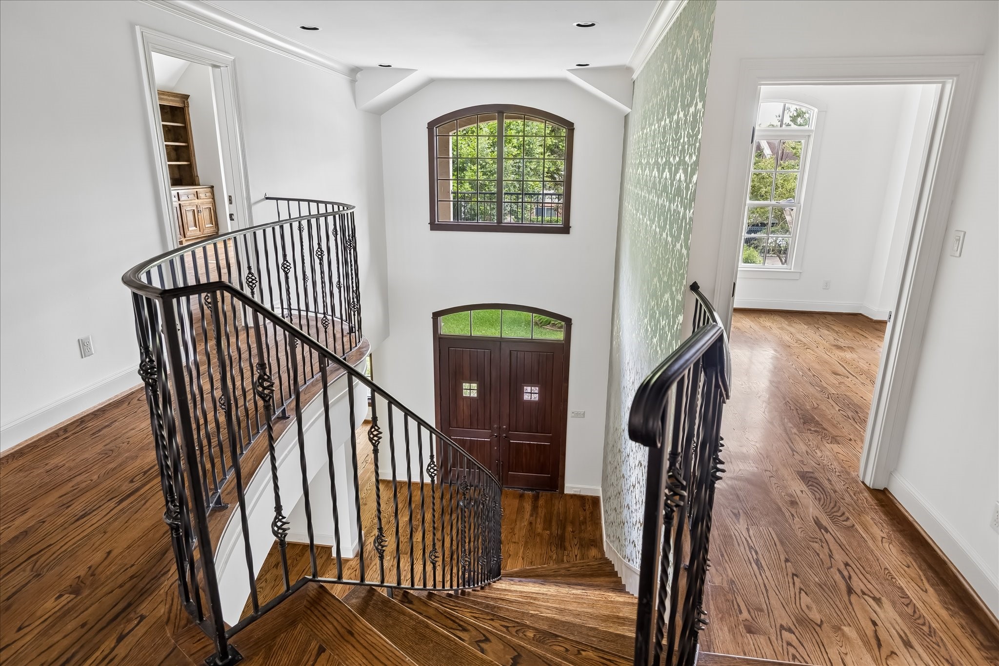 2246 Branard Street Houston, TX 77098 - Photo 22 of 40 Upper landing overlooks the dramatic two-story foyer and showcases the home’s sweeping staircase and custom ironwork.