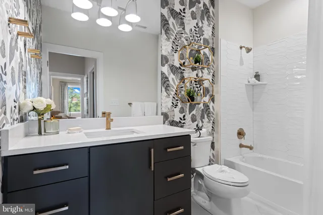 a bathroom with a double vanity sink toilet and shower