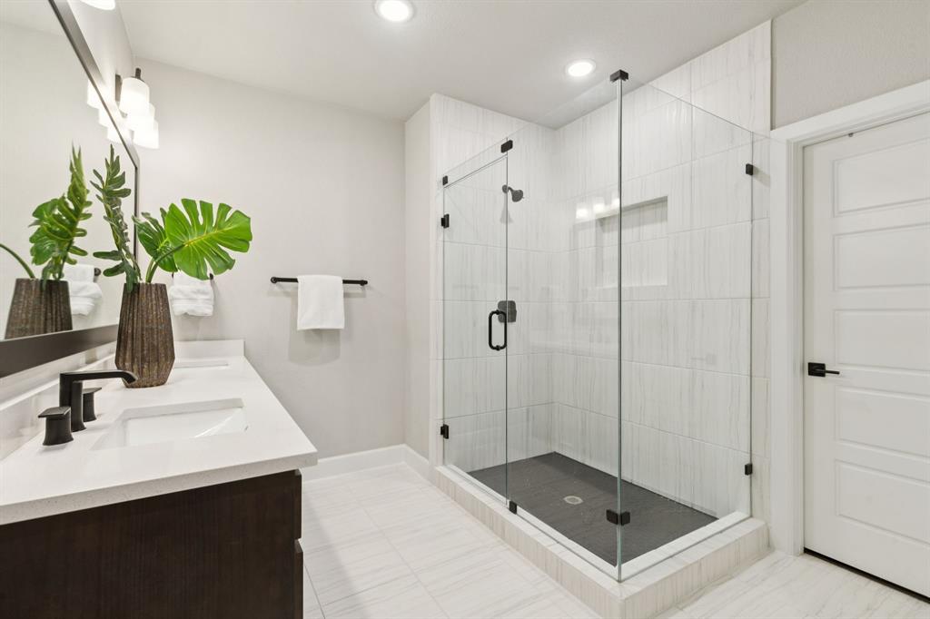 7121 Laurel Ridge Dallas, TX 75231 - Photo 15 of 25 a bathroom with a shower sink and mirror