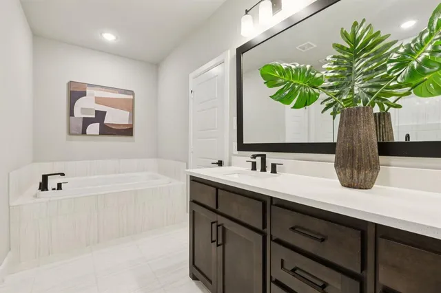 a bathroom with a sink a vanity and a bathtub
