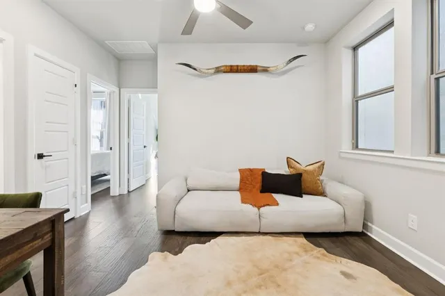 a living room with furniture and a wooden floor