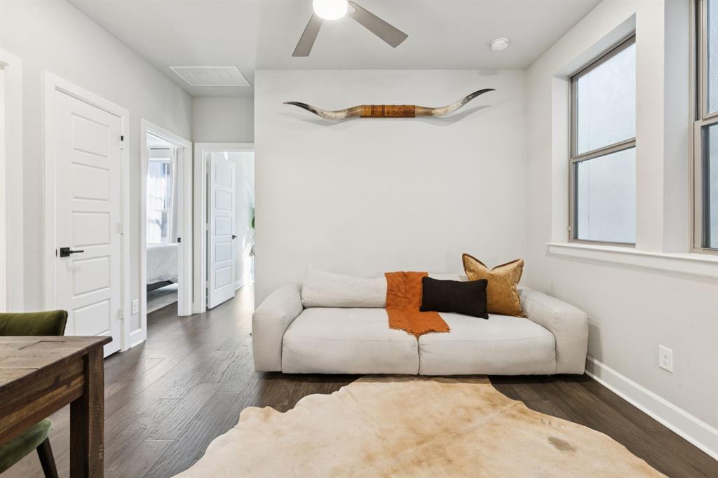 7121 Laurel Ridge Dallas, TX 75231 - Photo 20 of 25 a living room with furniture and a wooden floor