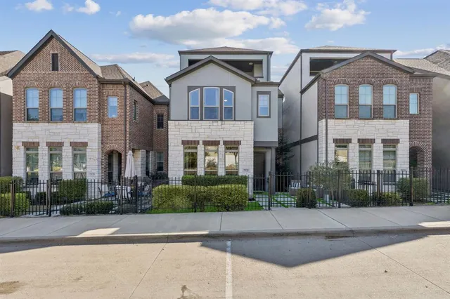 front view of a brick house with a yard
