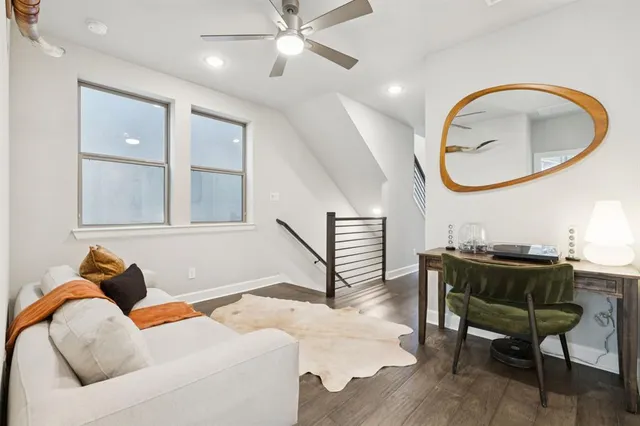 a living room with furniture a mirror and a painting on the wall