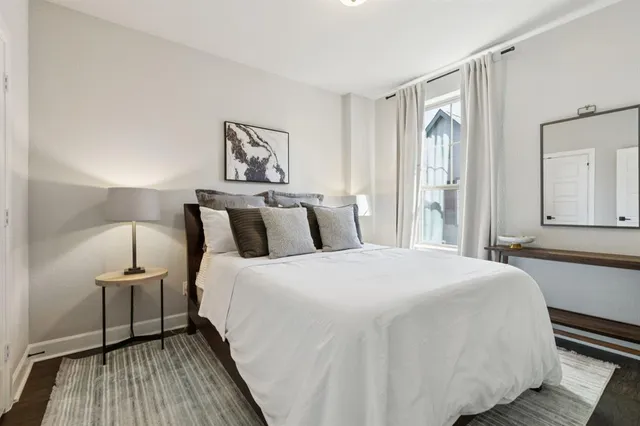 a bedroom with a bed and wooden floor