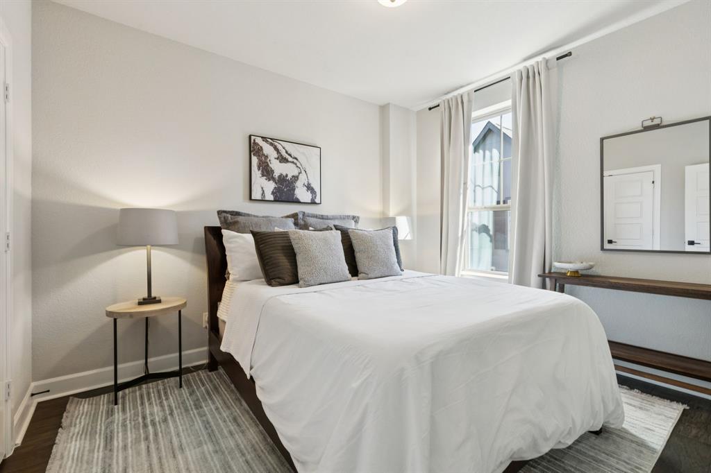 7121 Laurel Ridge Dallas, TX 75231 - Photo 22 of 25 a bedroom with a bed and wooden floor