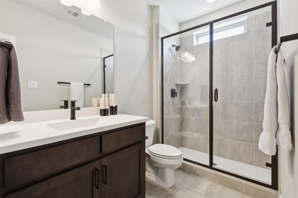 7121 Laurel Ridge Dallas, TX 75231 - Photo 25 of 25 a bathroom with a sink a toilet and shower