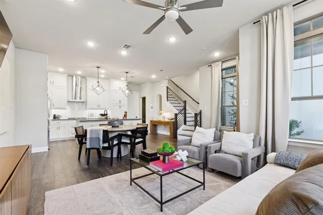 a living room with furniture and kitchen view