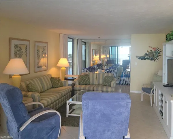 a living room with furniture and a lamp