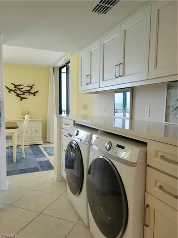 a utility room with sink dryer and washer