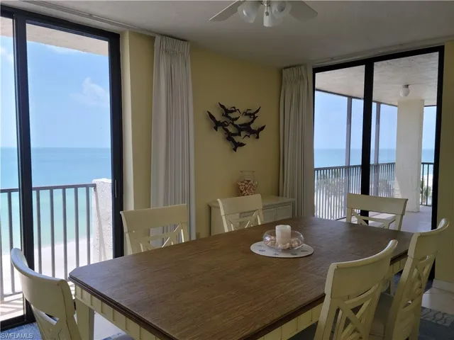 a view of a dining room with furniture a chandelier and wooden floor