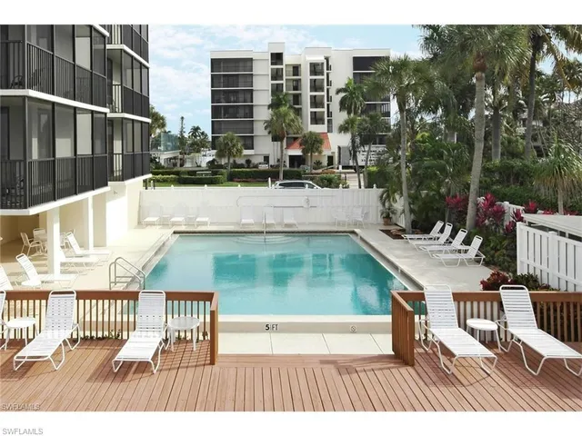 a couple of palm trees sitting in front of a house