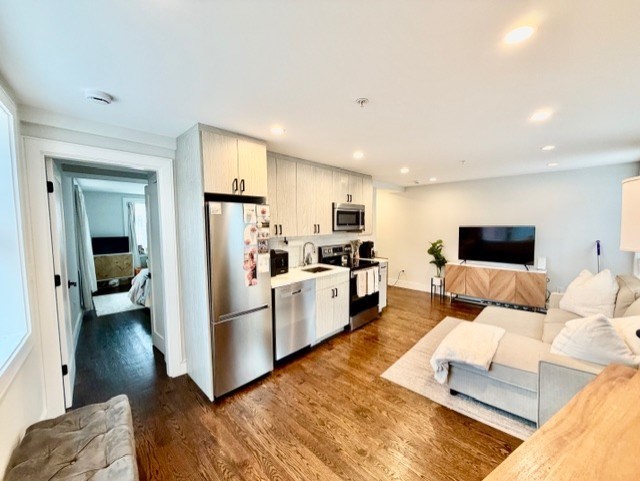 366 Hanover Street, Unit 4 Boston, MA 02113 - Photo 2 of 14 a living room with furniture and a couch