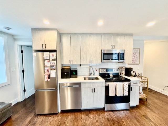 366 Hanover Street, Unit 4 Boston, MA 02113 - Photo 4 of 14 a kitchen with stainless steel appliances a stove a sink cabinets and a refrigerator
