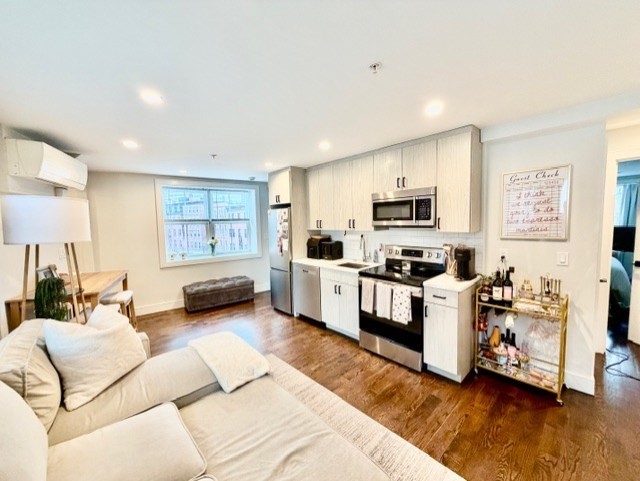 366 Hanover Street, Unit 4 Boston, MA 02113 - Photo 5 of 14 a living room with furniture and a wooden floor