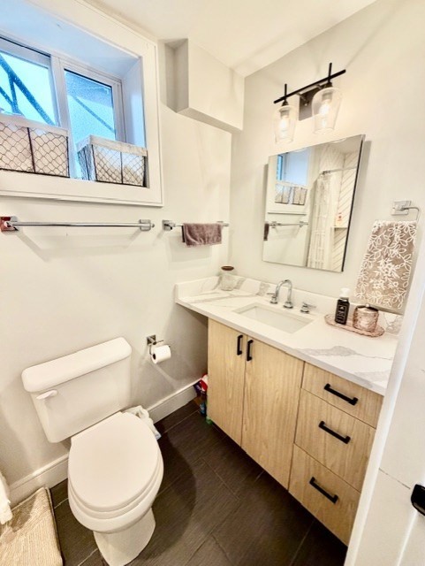 366 Hanover Street, Unit 4 Boston, MA 02113 - Photo 9 of 14 a bathroom with a toilet sink and mirror