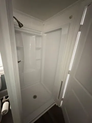 a bathroom with a glass shower door