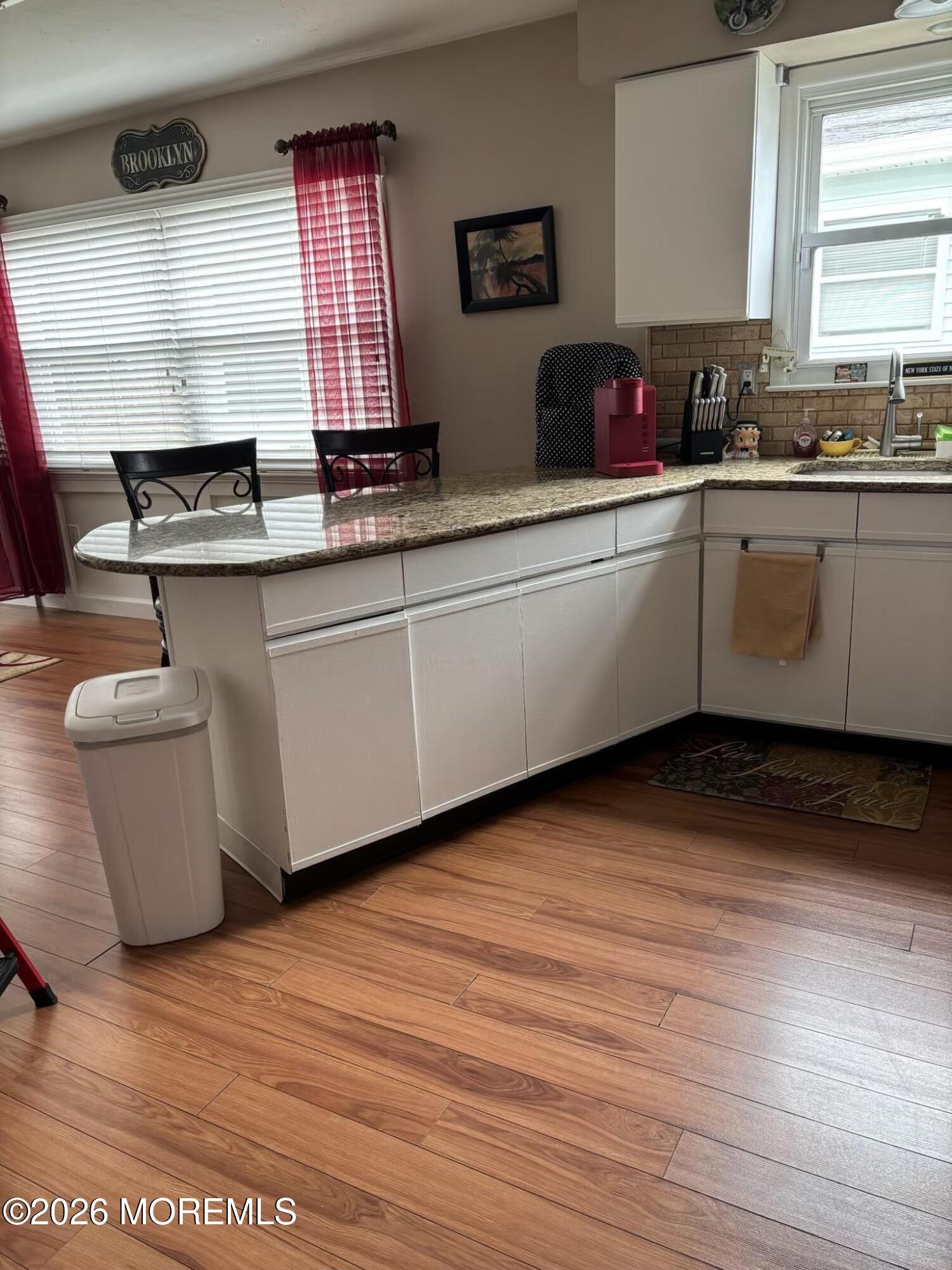 130 Courtshire Drive Brick, NJ 08723 - Photo 25 of 27 a kitchen with stainless steel appliances granite countertop a sink a stove a microwave and wooden floors