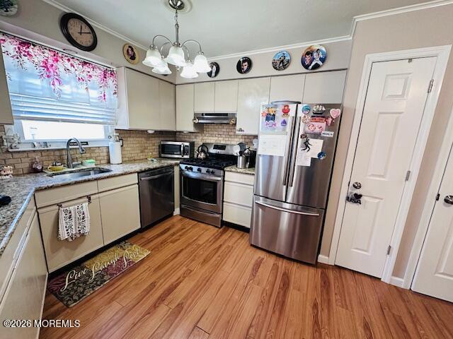 130 Courtshire Drive Brick, NJ 08723 - Photo 4 of 27 a kitchen with stainless steel appliances a stove a refrigerator and wooden floor