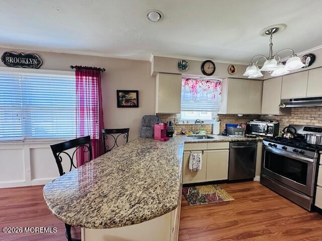 130 Courtshire Drive Brick, NJ 08723 - Photo 6 of 27 a kitchen with stainless steel appliances granite countertop a sink dishwasher stove and oven with wooden floor