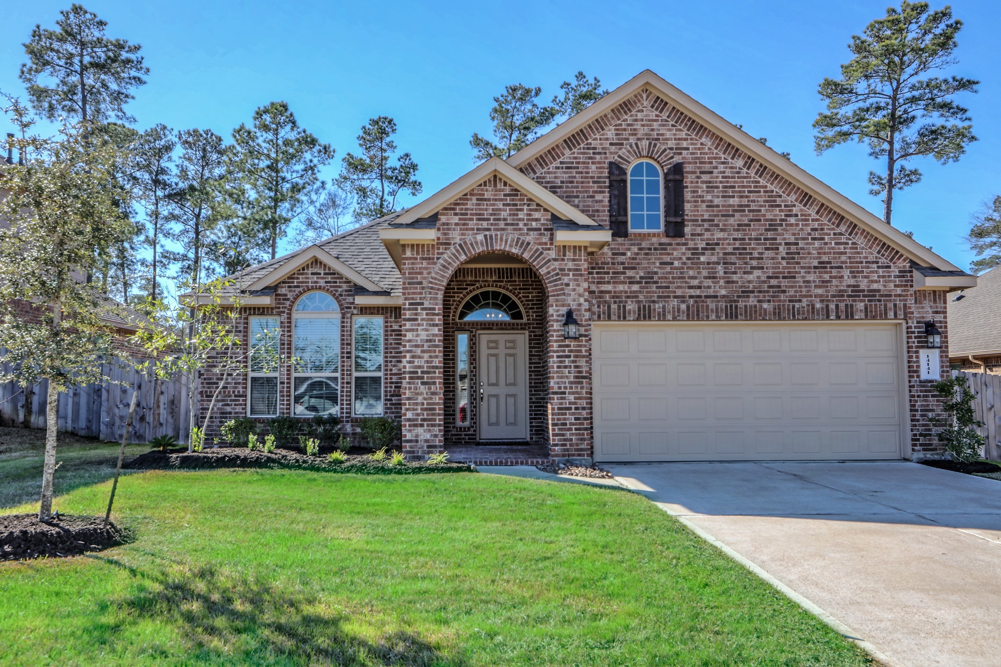 14141 Isle Royal Lane Conroe, TX 77384 - Photo 1 of 39 a front view of a house with garden