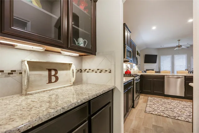 a kitchen with a sink stove and cabinets