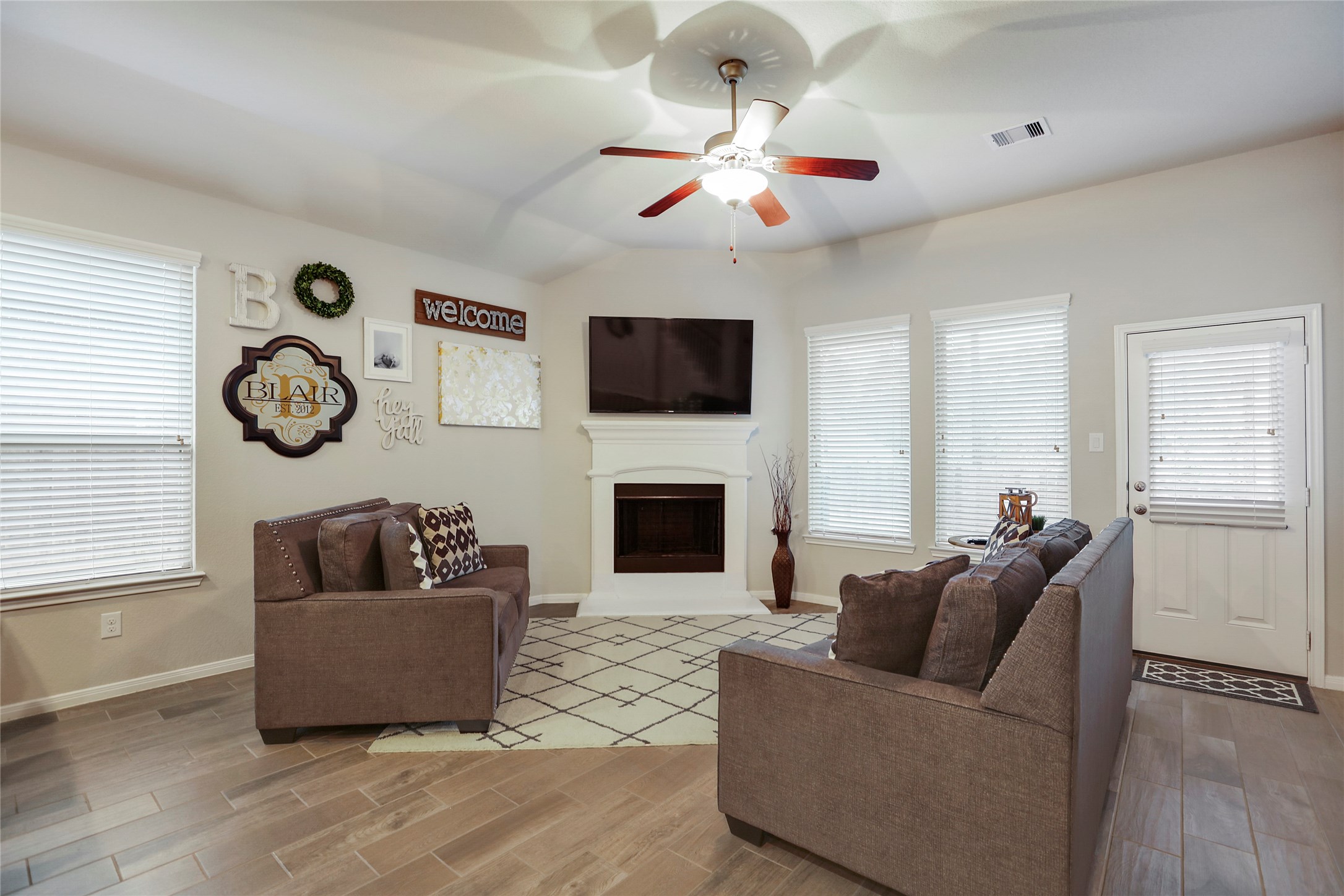 14141 Isle Royal Lane Conroe, TX 77384 - Photo 18 of 39 a living room with furniture and a flat screen tv