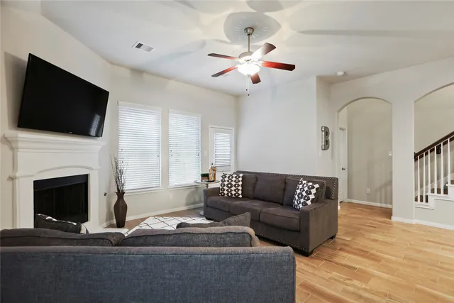 a living room with furniture and kitchen view
