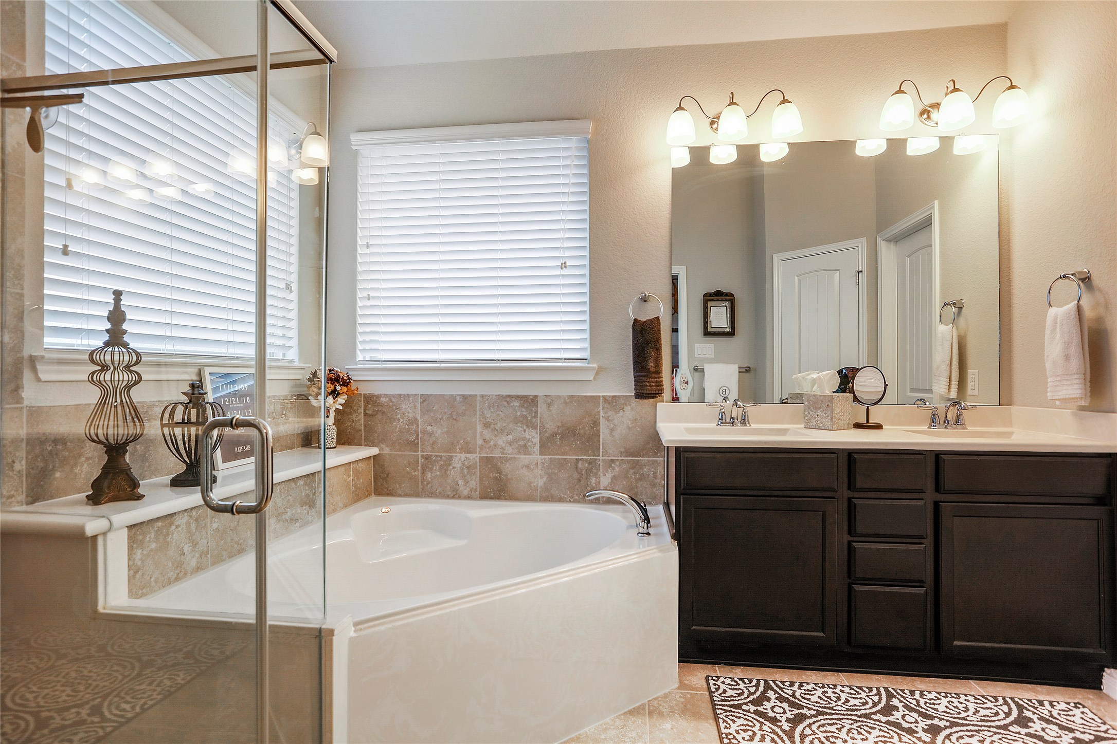 14141 Isle Royal Lane Conroe, TX 77384 - Photo 25 of 39 a bathroom with a tub sink and mirror