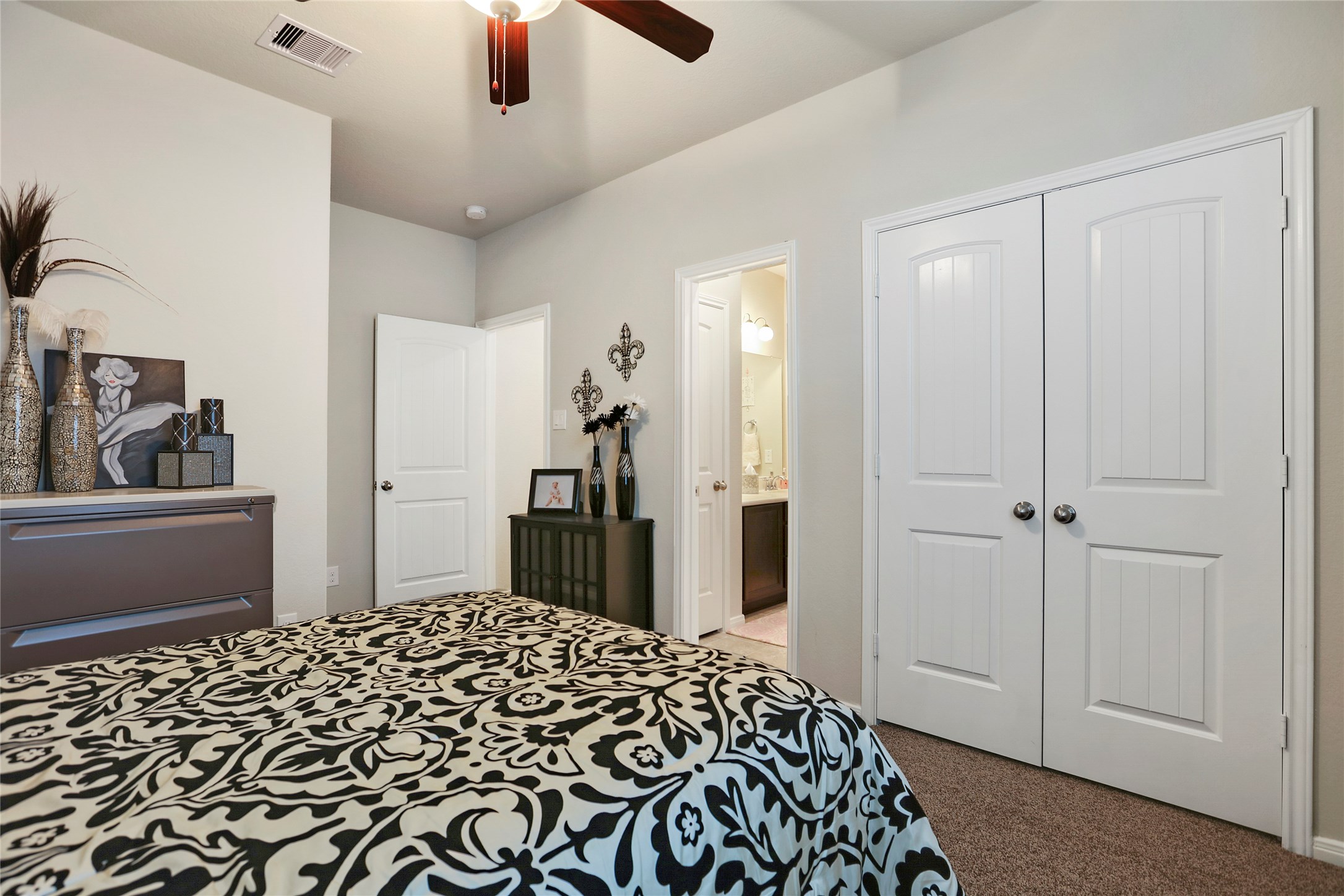 14141 Isle Royal Lane Conroe, TX 77384 - Photo 30 of 39 a bedroom with a bed and a dresser