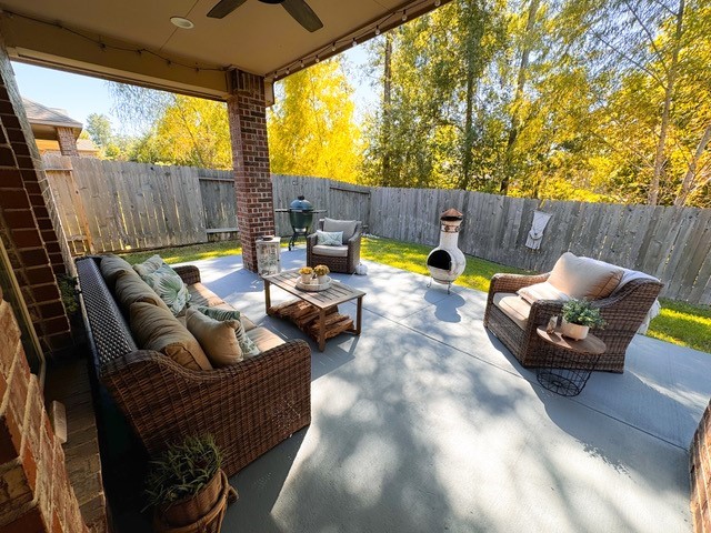 14141 Isle Royal Lane Conroe, TX 77384 - Photo 35 of 39 a view of a patio with couches table and chairs and potted plants