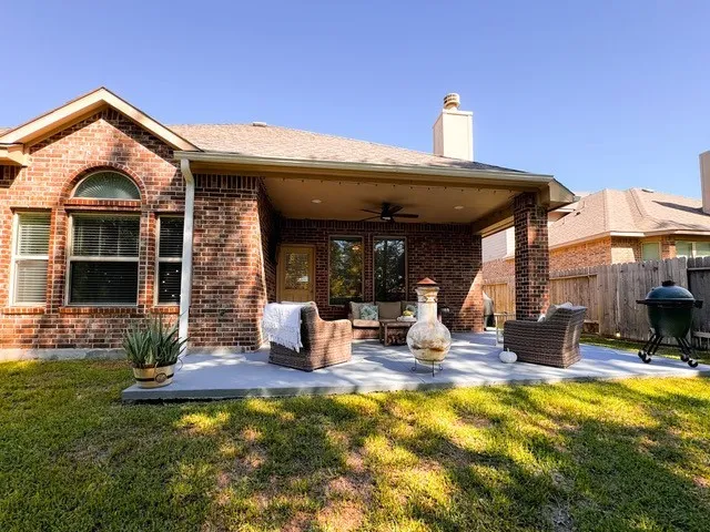 a view of a house with backyard porch and sitting area